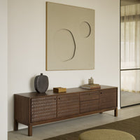 Wooden sideboard in rich brown with textured woven patterns, complemented by a neutral, modern art piece above.