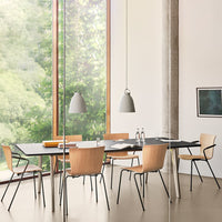 Modern dining room with natural wood tones, black table, beige accents, and minimalist grey pendant lights.