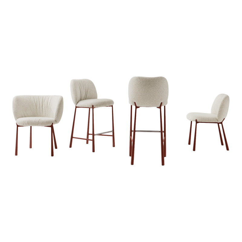 Set of four chairs featuring soft cream upholstery and sleek red metal legs in minimalist design.