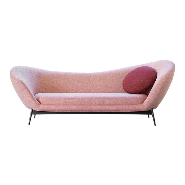 Modern pink sofa with a gradient design and a round maroon cushion accent. Sleek black legs complete the look.