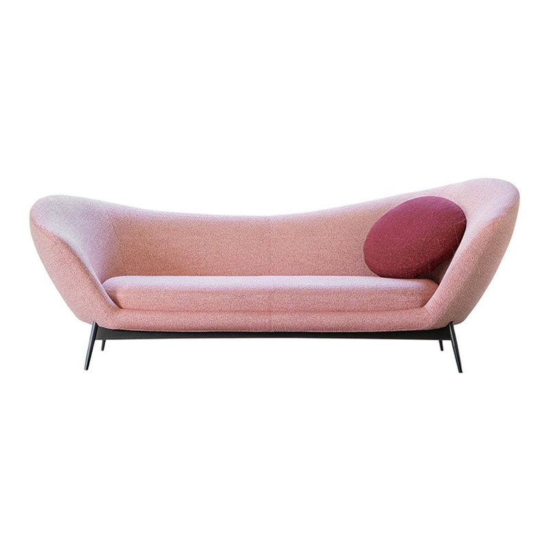 Modern pink sofa with a gradient design and a round maroon cushion accent. Sleek black legs complete the look.