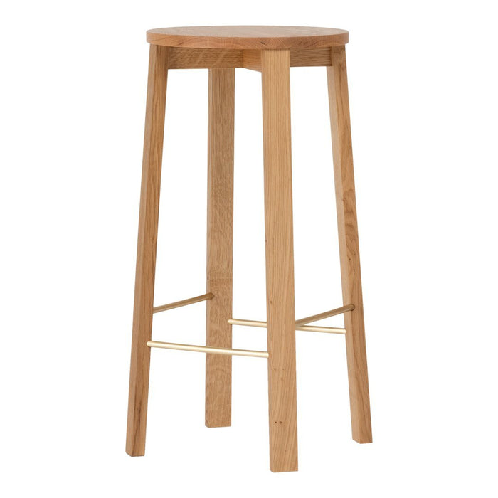 Natural light wood bar stool with a smooth, round top and minimalist design, accented by a gold footrest.