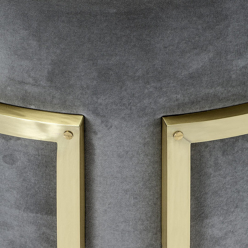 "Close-up of grey velvet fabric with elegant golden metal accents, showcasing rich textures and modern design elements."