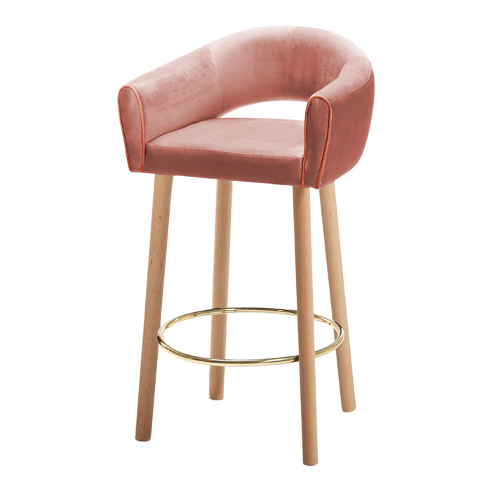 Pink velvet bar stool with golden accents and natural wood legs, featuring a modern, curved design.