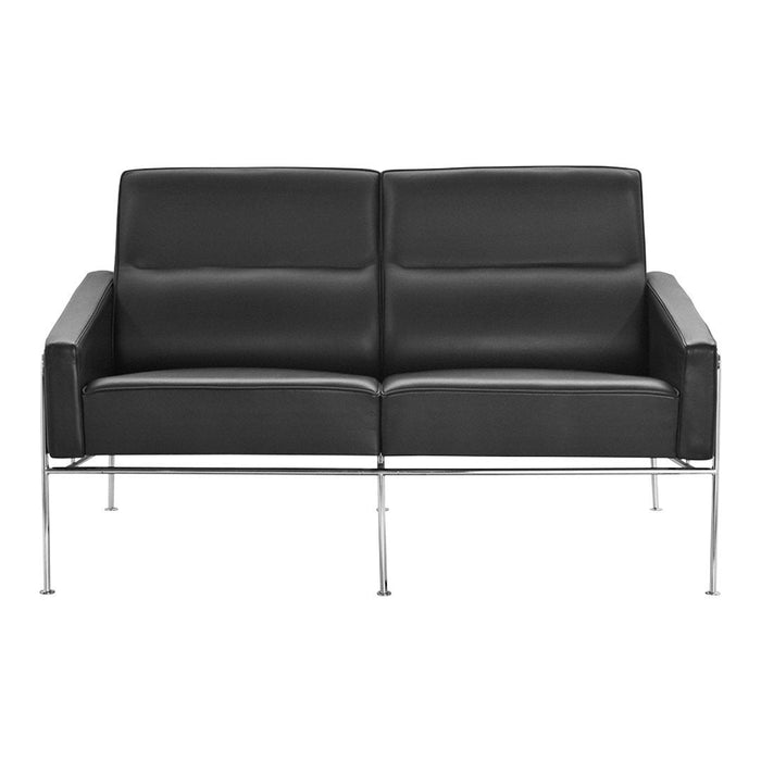 Sleek black leather loveseat with minimalist chrome legs, featuring smooth, modern cushions and a contemporary design.