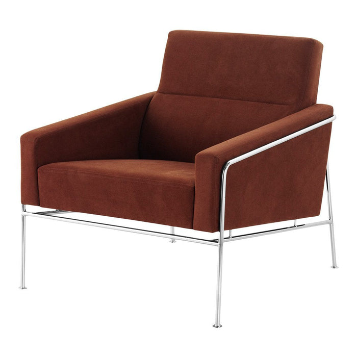 "Modern brown velvet armchair with sleek chrome legs, perfect for contemporary decor."