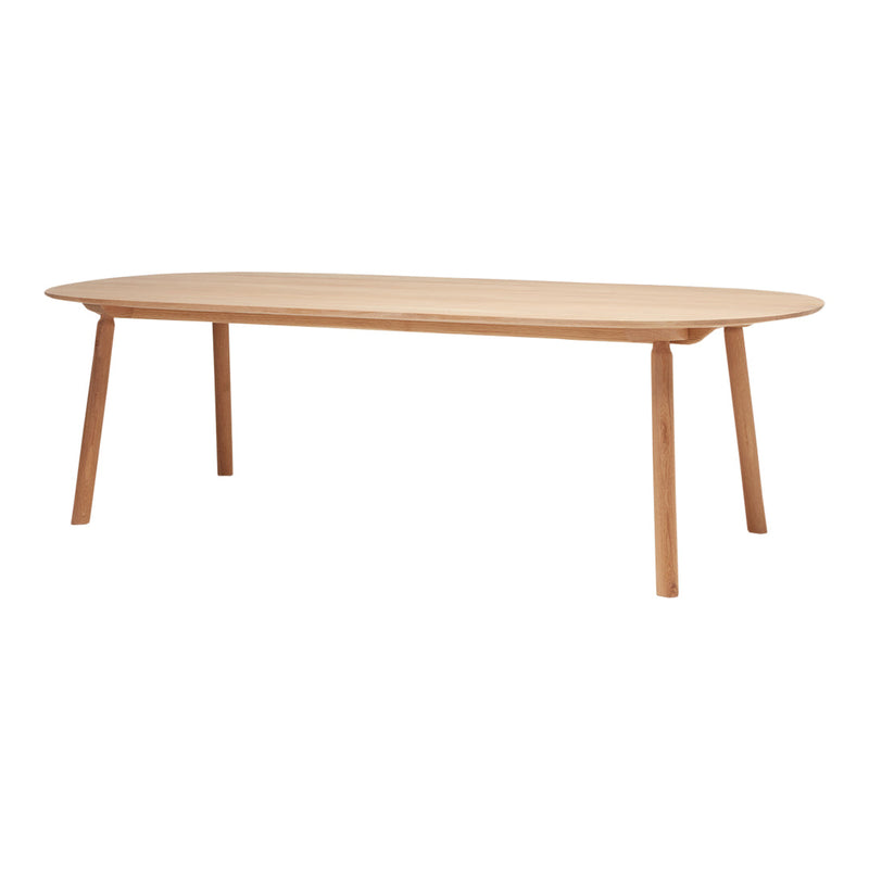 Light oak dining table with a smooth, oval top and natural wood finish, complemented by simple, tapered legs.
