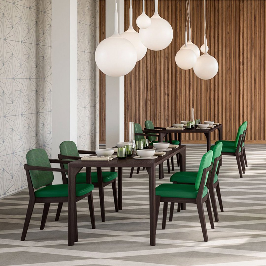 Modern dining set featuring dark wood and vibrant green cushions, set against a geometric patterned floor.