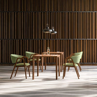 "Light green chairs with wood accents around a wooden table against a dark wood slatted backdrop."