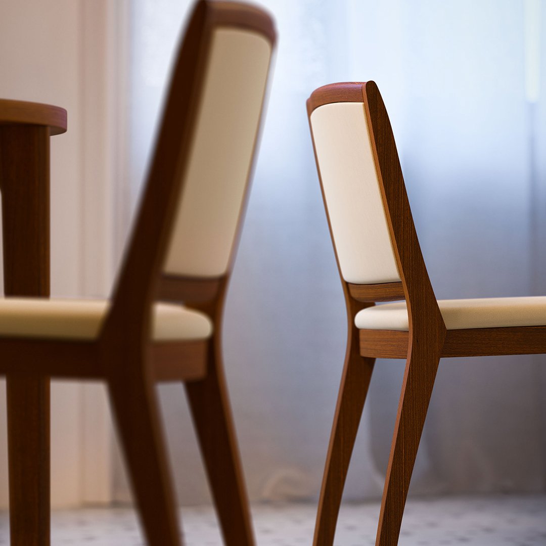 Elegant wooden chairs with cream upholstery, showcasing smooth lines and a modern design against a soft backdrop.