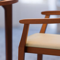 Light beige fabric seat with rich brown wooden frame, showcasing minimalist design and clean lines.