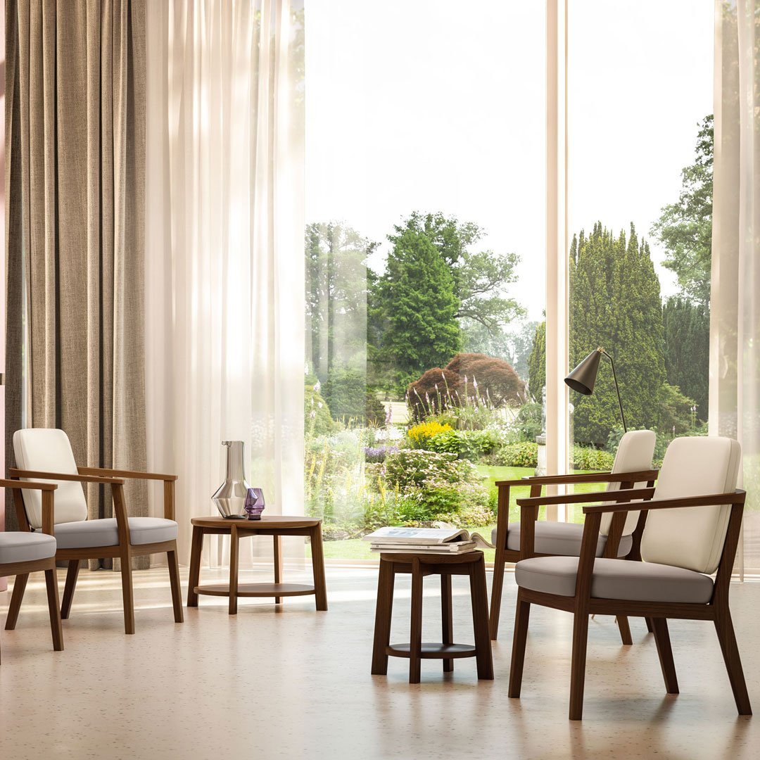 "Elegant beige and gray patterned chairs with wooden frames, set against a bright, airy room with natural light."