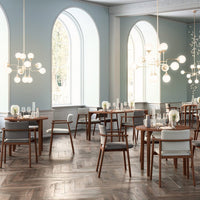 Elegant dining room featuring light blue walls, rich wood floors, and stylish light fixtures with white and gold accents.
