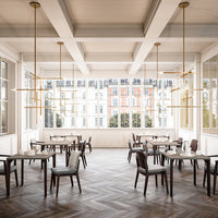 Elegant dining area featuring light wood hues, dark brown chairs, and geometric patterns on a herringbone floor.