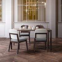 Elegant dining set with light gray and white upholstery, showcasing a warm wood finish and a herringbone-patterned floor.