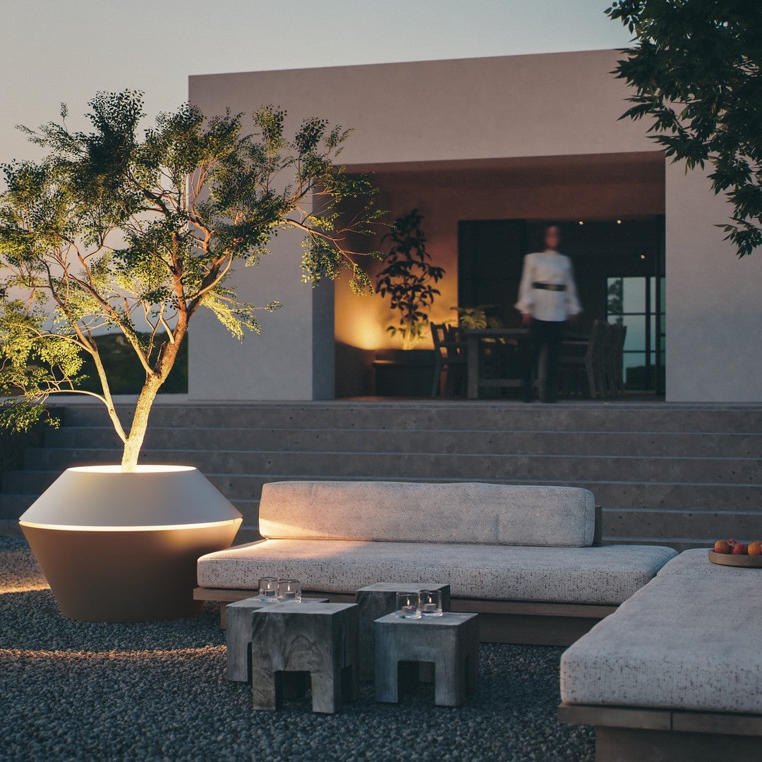 Contemporary outdoor lounge set featuring neutral tones, textured fabrics, and earthy stone accents.