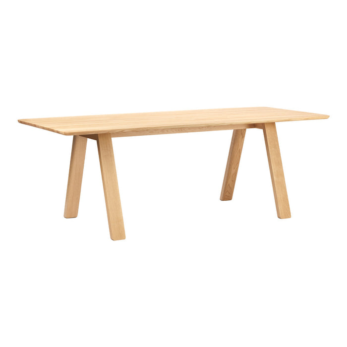 Light natural wood dining table with a smooth, minimalist surface and tapered legs, showcasing warm beige tones.