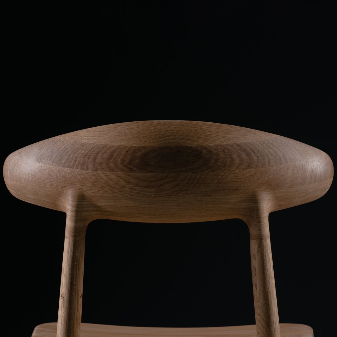 Natural wood grain pattern with warm brown tones against a sleek black background. Modern minimalist design.