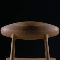 Natural wood grain pattern with warm brown tones against a sleek black background. Modern minimalist design.