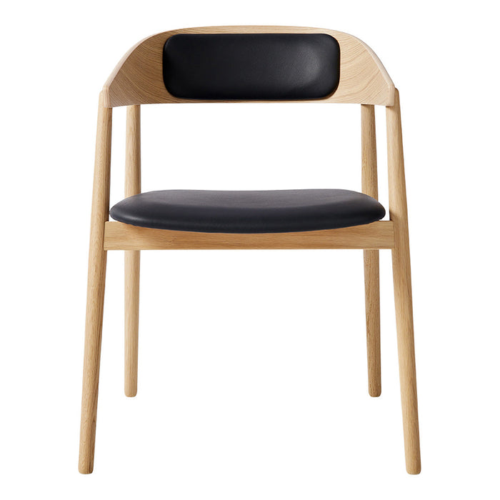 Modern chair with natural wood finish and sleek black leather seat and backrest. Simple, elegant design for any decor.