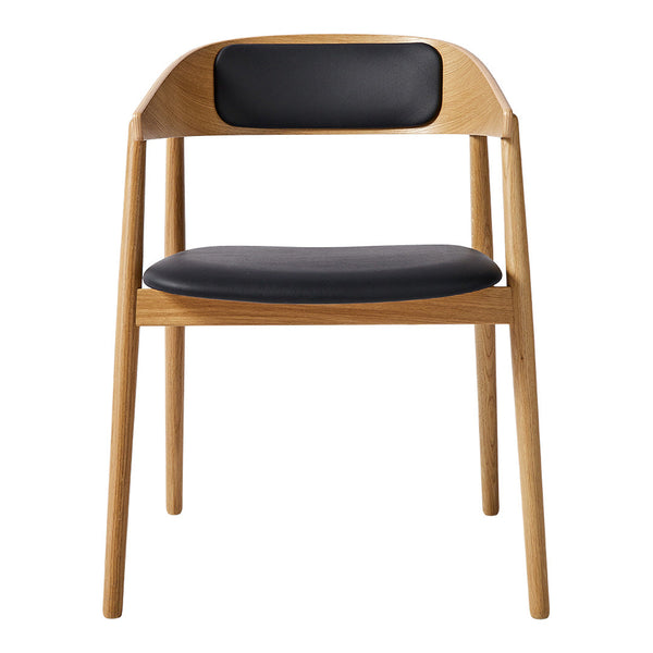Natural wood chair with a light oak finish and a sleek black leather seat and back for a modern touch.