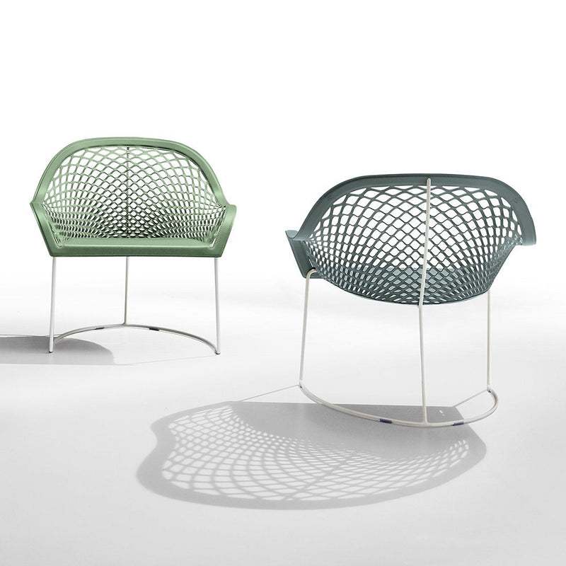 Green and teal net-patterned chairs on white background, showcasing modern design and sleek metal legs.