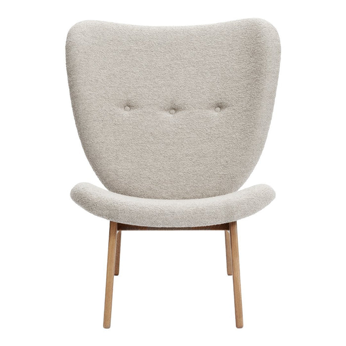Light beige upholstered chair with a curved back and wooden legs, featuring a subtle tufted pattern.