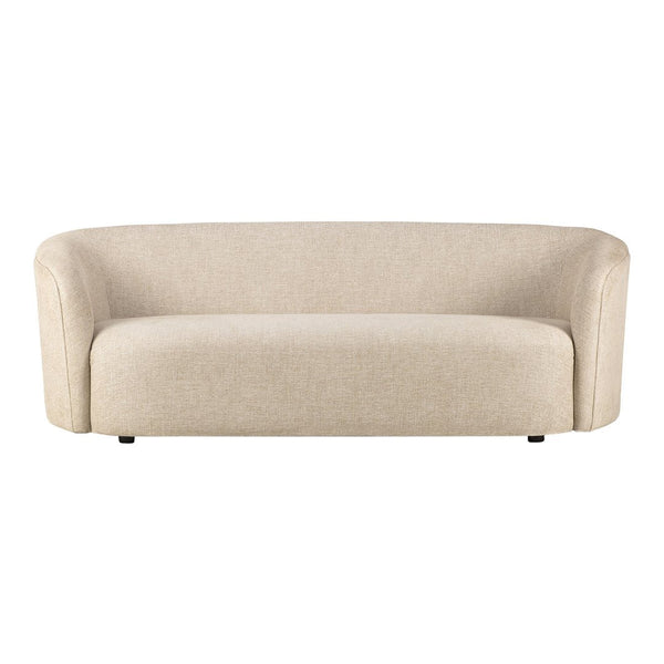 Beige curved sofa with a smooth, textured finish, ideal for modern living spaces.