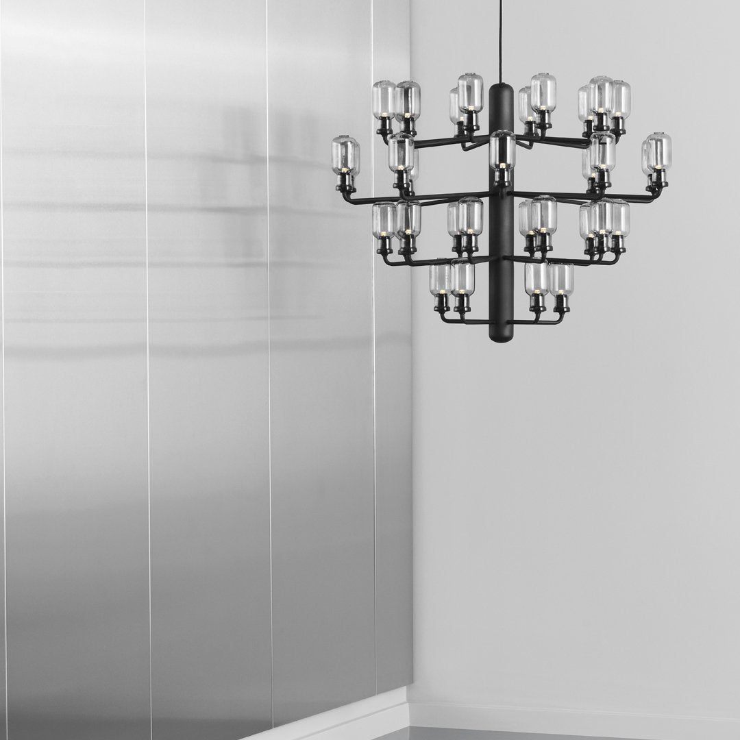 "Elegant black chandelier with geometric arms and clear glass shades, perfect for modern decor."