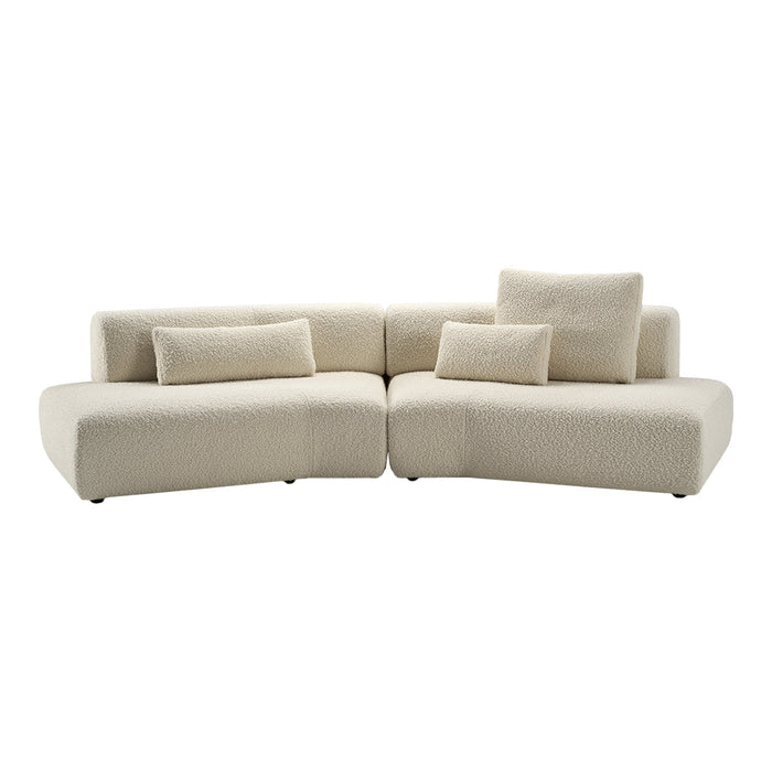 Luxurious cream-colored sofa with a smooth, textured fabric and minimalist design, featuring plush back cushions.
