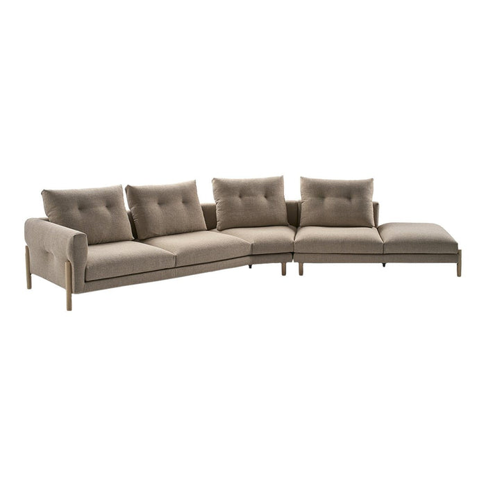 L-shaped sofa in soft taupe fabric with tufted cushions and light wood legs. Modern and elegant design.
