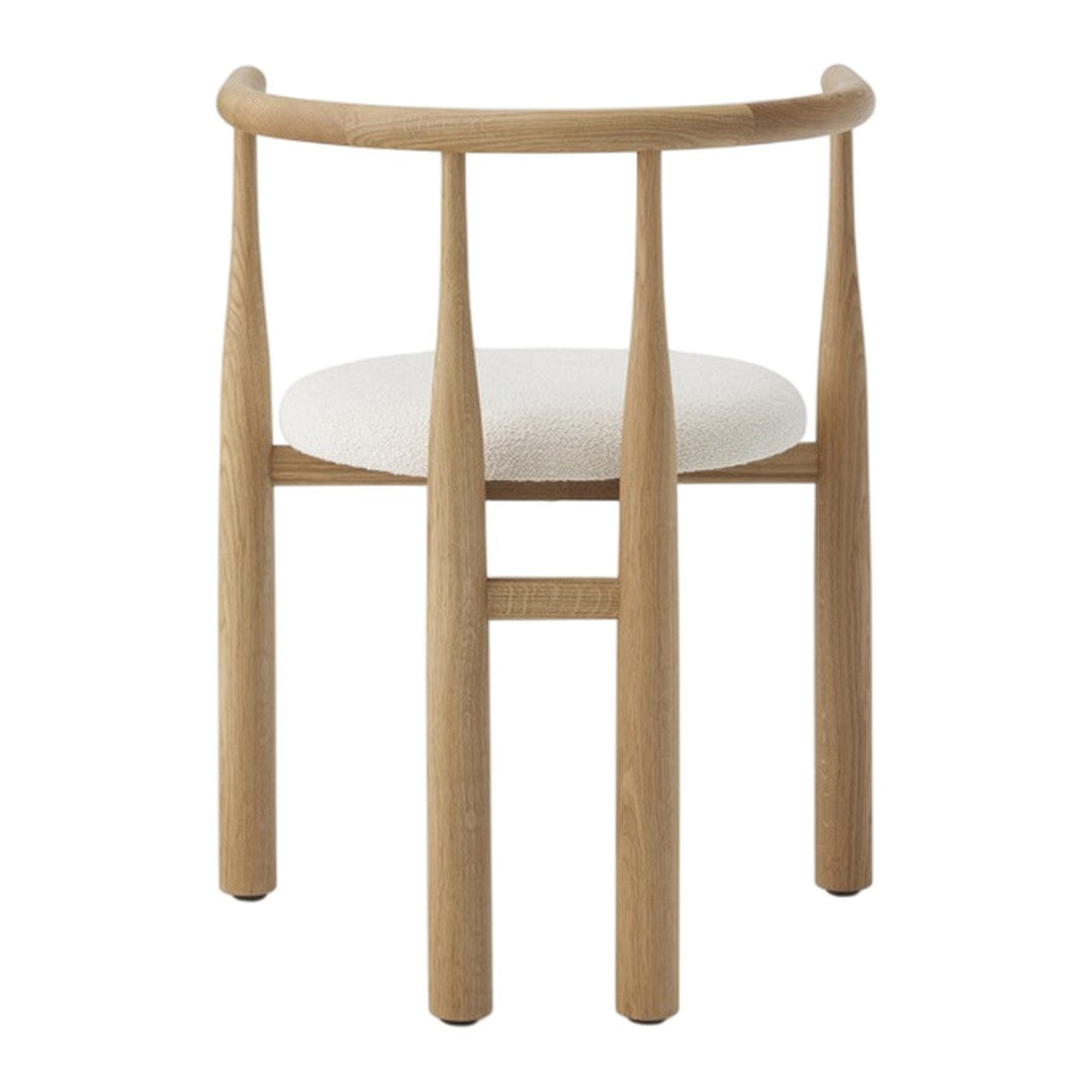 Wooden chair with a white cushion on a white background