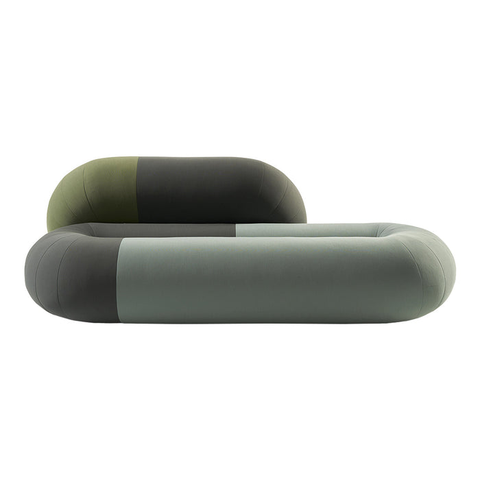 Modern couch in soft green, dark green, and muted gray tones with smooth, rounded shapes and minimalistic design.