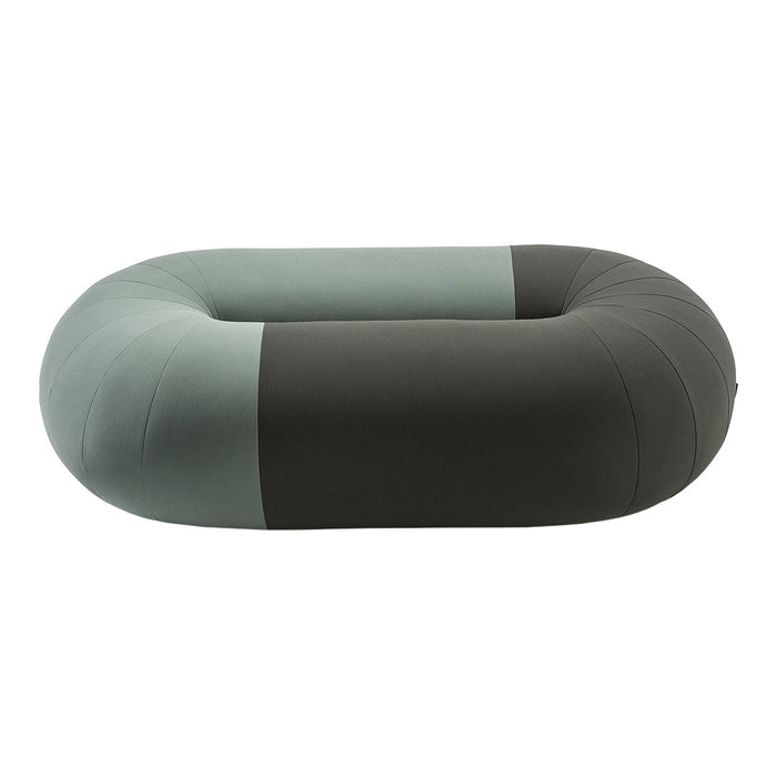Stylish oval pet bed with a two-tone design featuring muted gray and soft green hues.