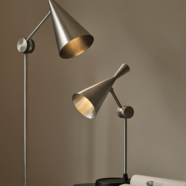 Metallic silver cone-shaped lamps with sleek modern design on a neutral background.
