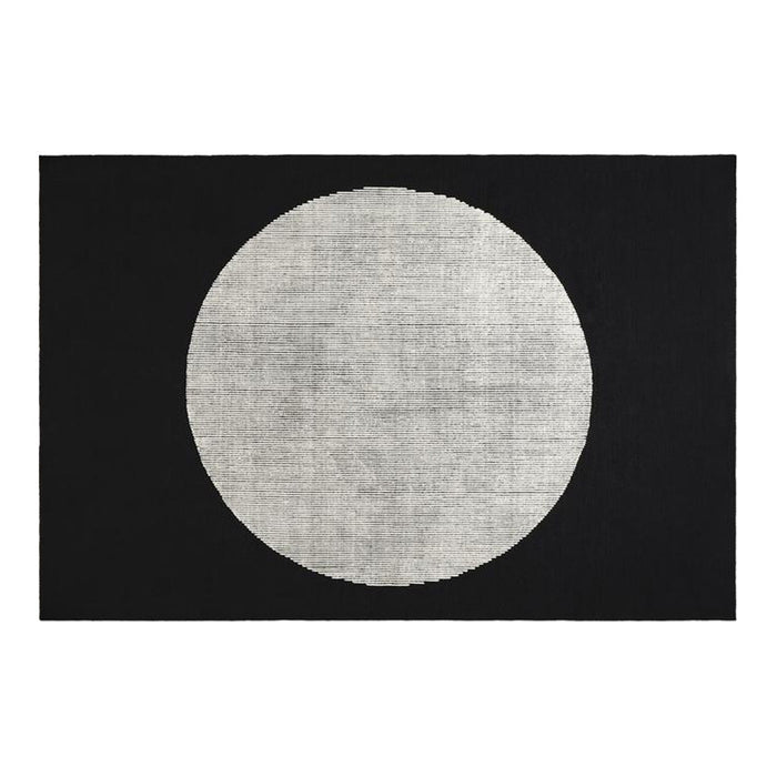 Black rug featuring a large white circular pattern, ideal for modern decor. Perfect contrast for stylish interiors.