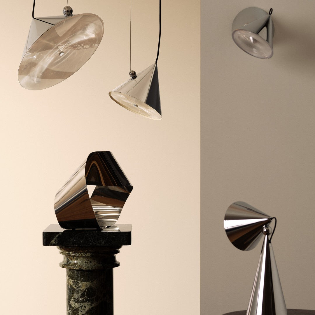 Modern metal lamps in sleek silver and chrome with geometric shapes and a minimalist design on a soft beige background.