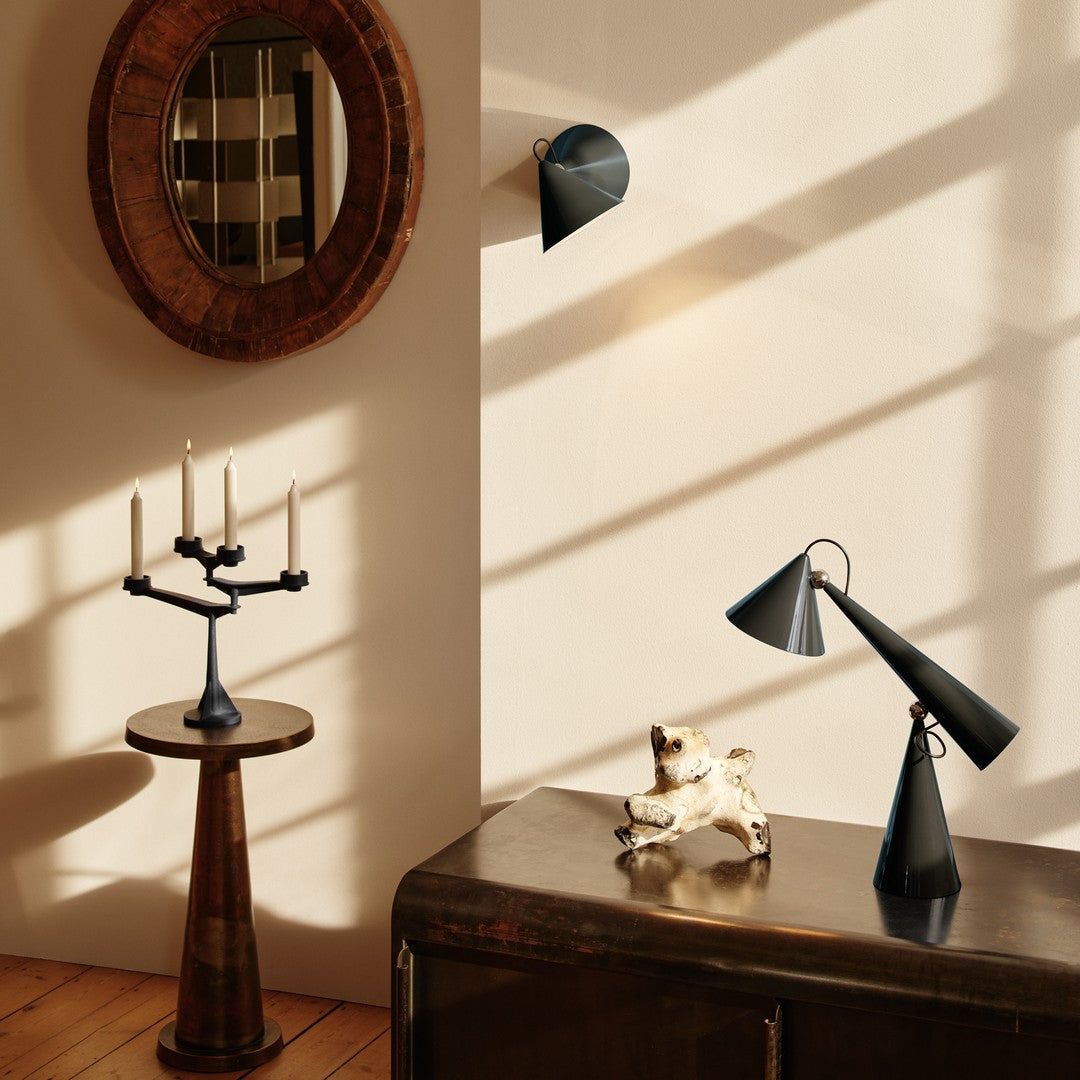 "Stylish black and gold decor with geometric patterns and warm wooden tones, perfect for modern interiors."