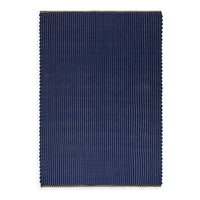 Navy blue rectangular rug with a subtle striped pattern and scalloped edges, adding texture and style.