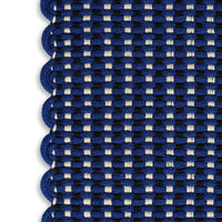Navy blue and cream patterned rug with scalloped edges, featuring a woven check design.