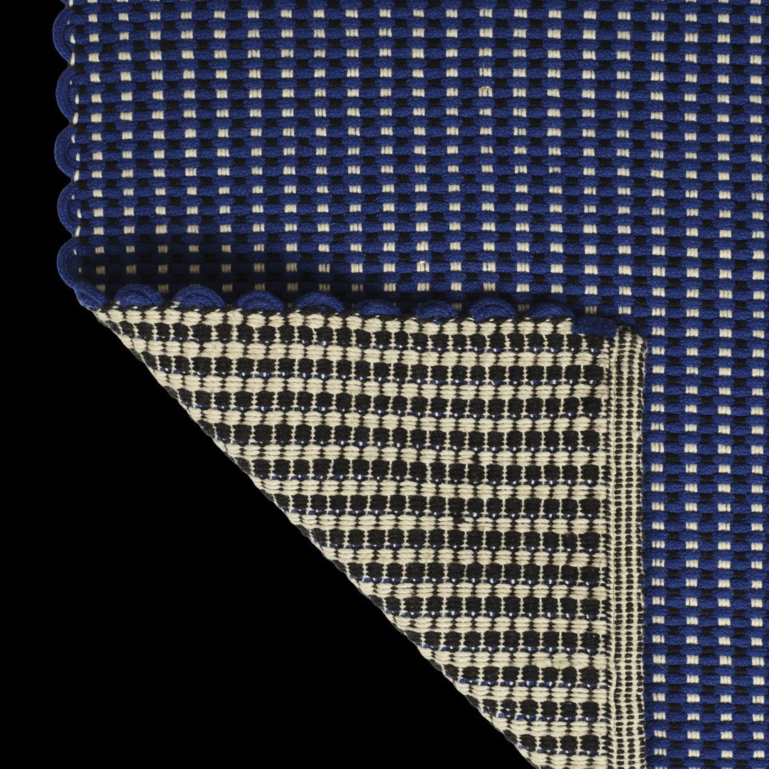 Navy blue and cream checked pattern with scalloped edges on one side, showcasing a textured woven design.