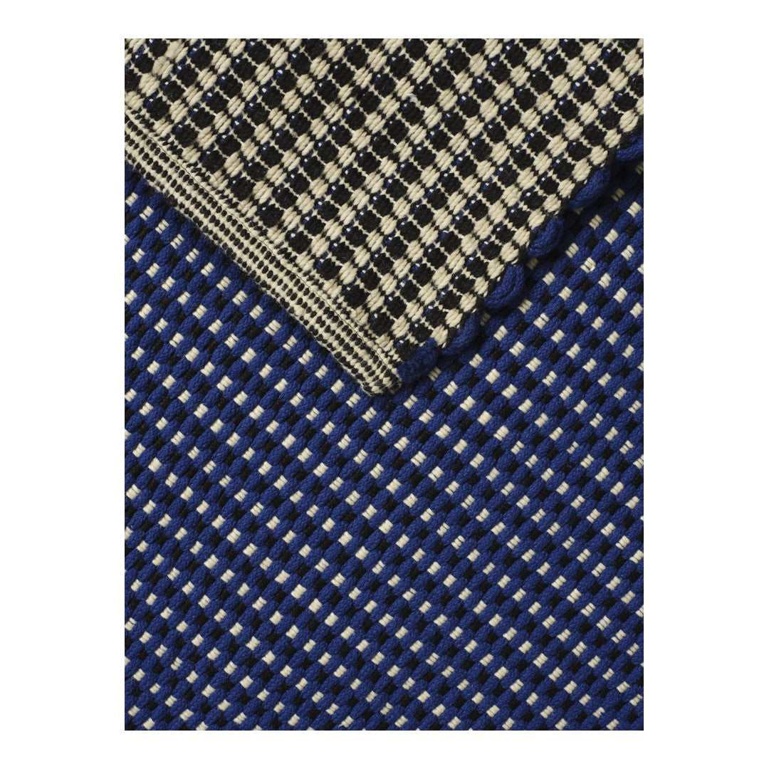 Navy and cream woven fabric featuring a checkered pattern with contrasting textures. Ideal for stylish decor or fashion.