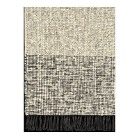 Textured throw blanket featuring a cream and black pattern with fringed edges. Modern and cozy decor accent.