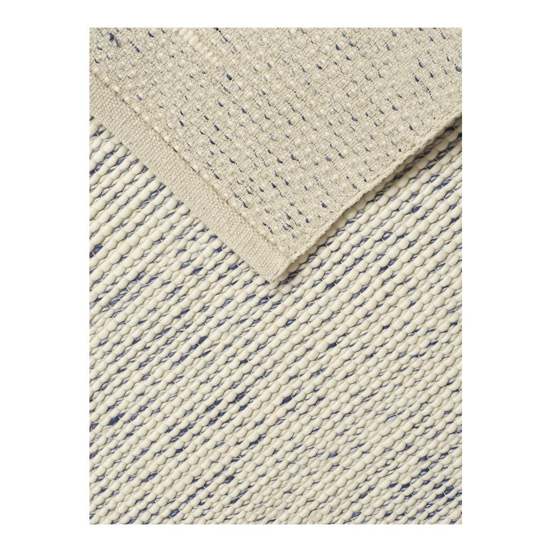 Beige textured rug with navy blue stripes and a solid beige border pattern. Ideal for modern decor.