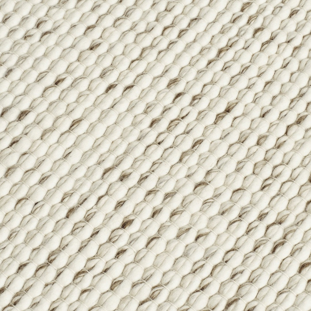 Textured cream and beige woven fabric with a diagonal pattern. Ideal for home decor or fashion projects.