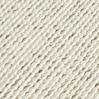 Textured cream and beige woven fabric with a diagonal pattern. Ideal for home decor or fashion projects.