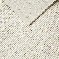 Textured cream fabric featuring diagonal stripes and a soft, contrasting border. Ideal for home decor.