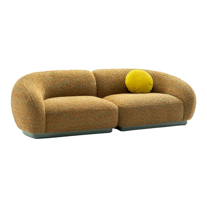 Rounded orange textured sofa with a vibrant yellow accent pillow, featuring a unique multicolored pattern.