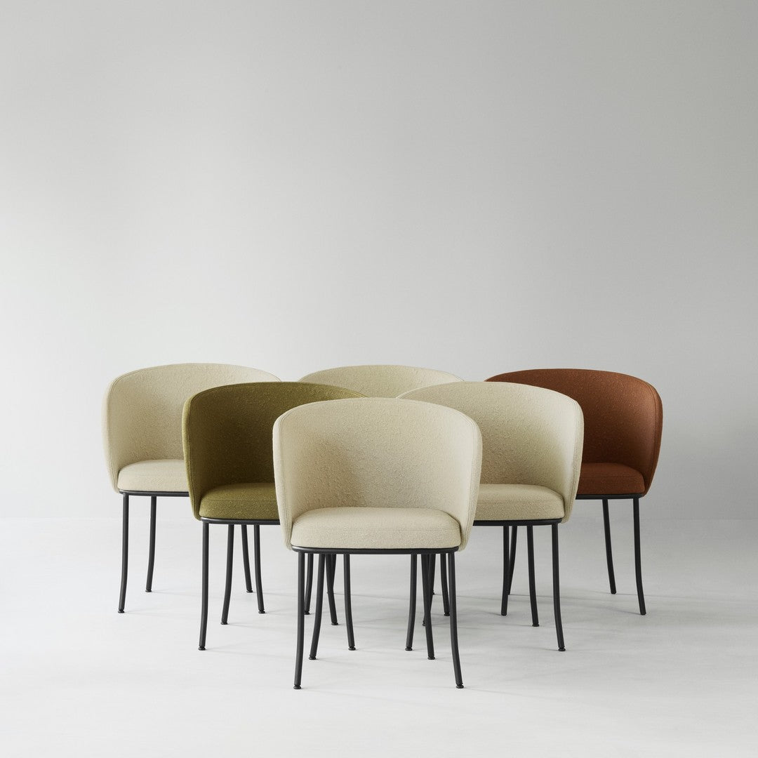 Set of modern chairs in soft beige, muted olive, and rich rust, featuring a textured finish and sleek black legs.