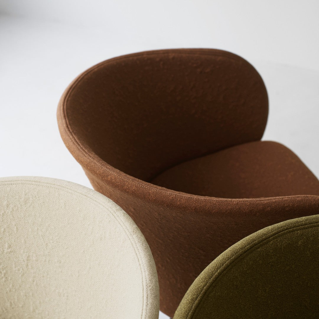 Chic, cozy chairs in cream, rich brown, and muted olive, featuring soft textures and modern silhouettes.